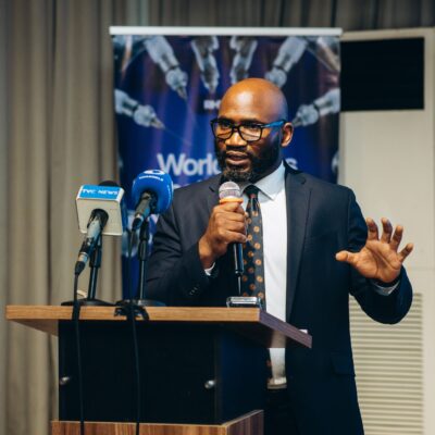 Professor Obi Davies-Ekwenna speaking at podium during Redeemer’s Health Village Robotics Surgery Launch Dinner following West Africa’s first tele-robotic surgery.