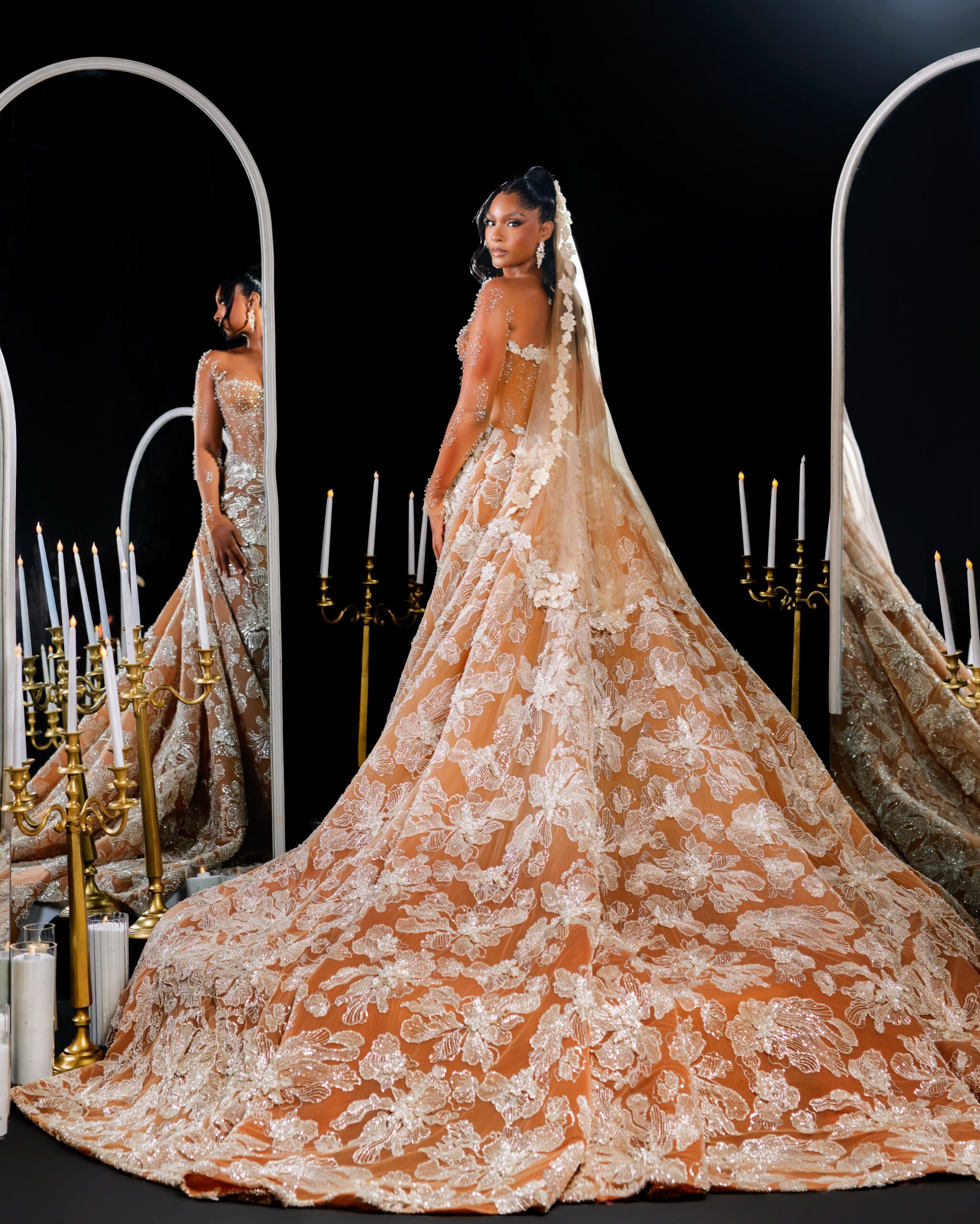 Osas Ighodaro from the back showing a long lace bridal veil and chapel train by Veekee James
