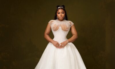 Veekee James in a full white basque-waist ballgown with an embellished corset