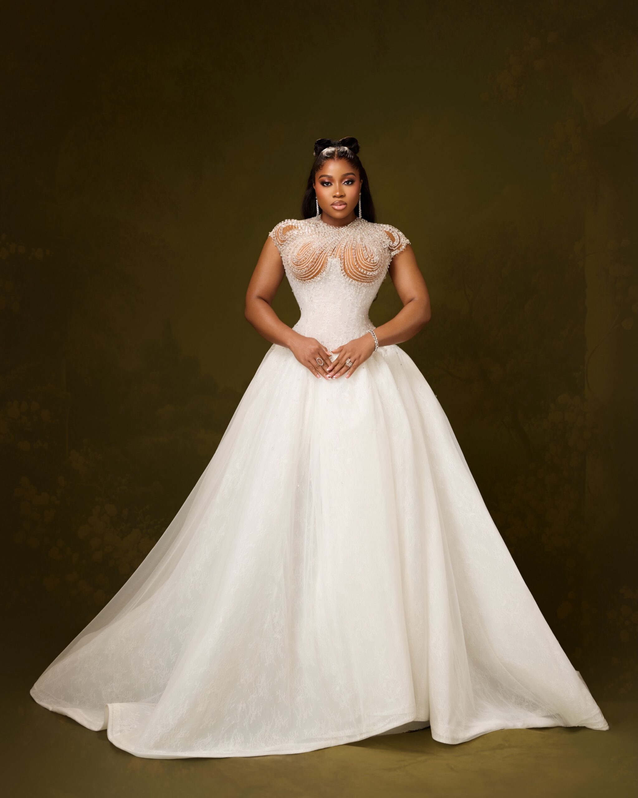 Veekee James in a full white basque-waist ballgown with an embellished corset
