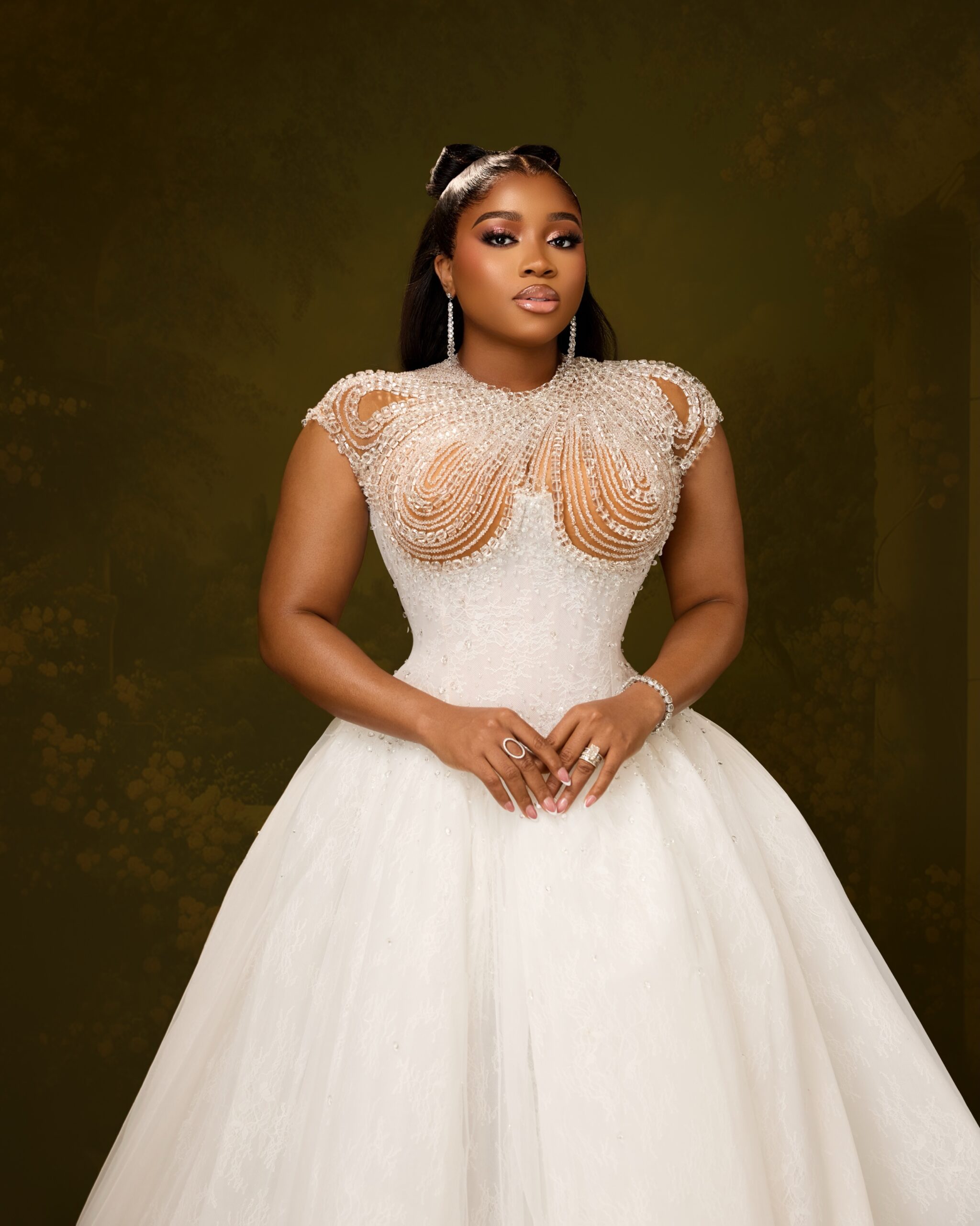 Veekee James displaying a crystal beaded sheer bodice and half-up bow hairstyle