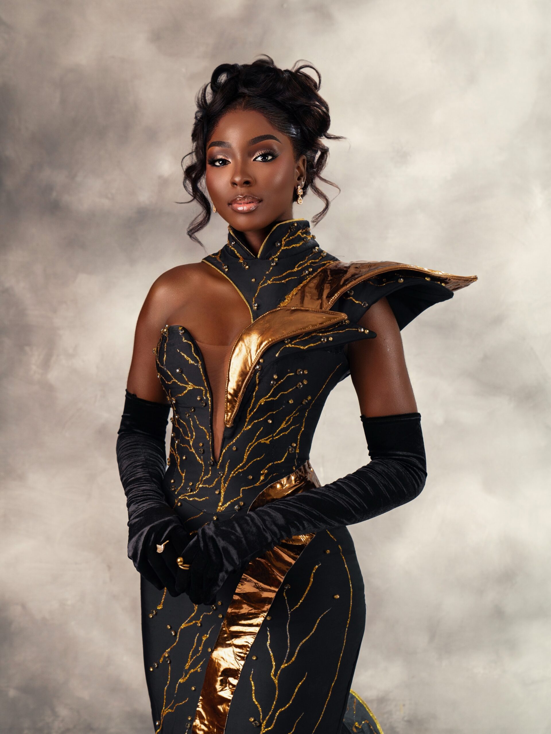 Alt Text: Tamunosoye Karibi-George in a black and gold gown at the Miss World 2026 Vietnam Flag Hoisting Ceremony, where she finished in the Top 12.