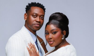 Mo Bimpe showcasing a high beehive updo and glam makeup next to Lateef Adedimeji