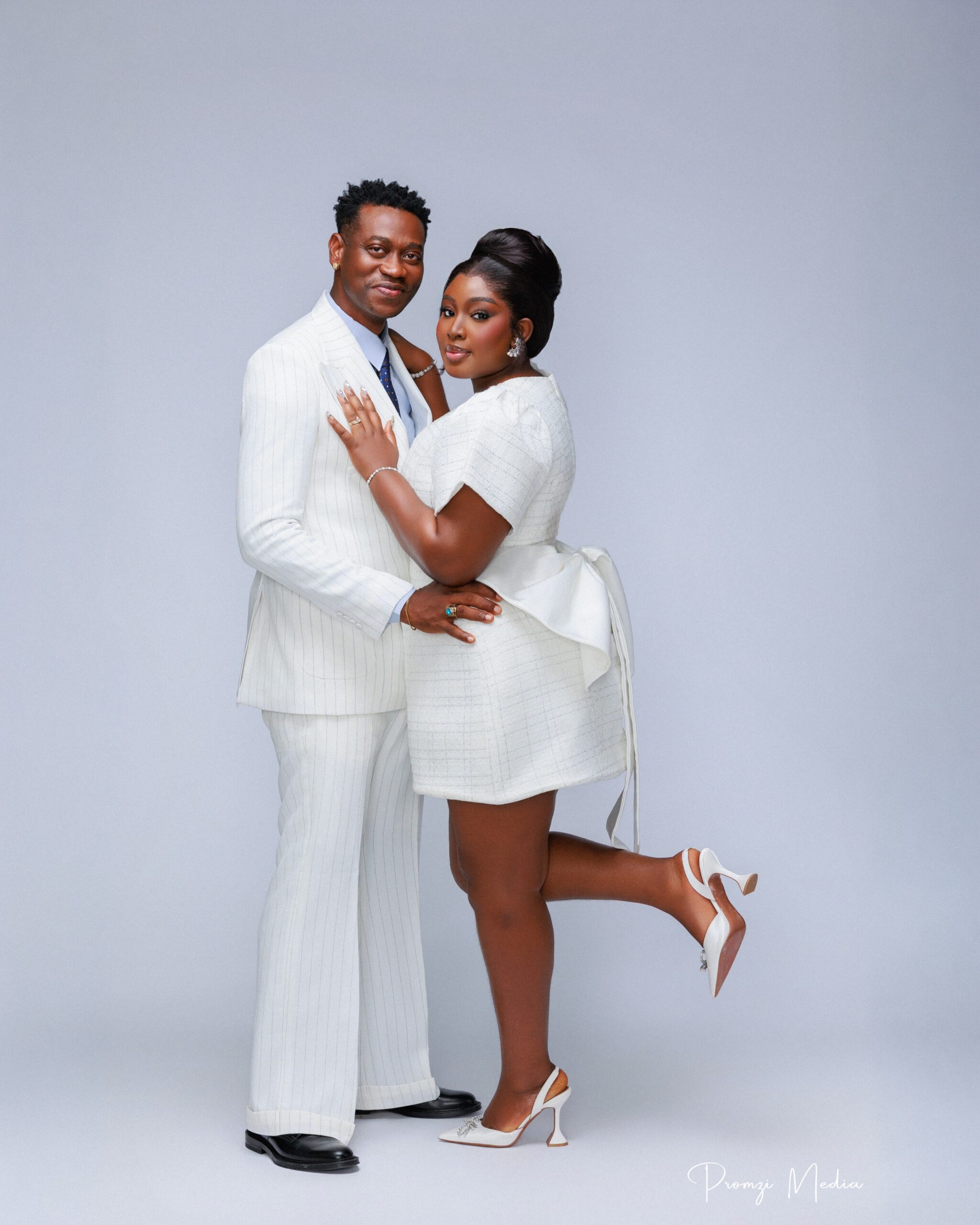 Lateef Adedimeji in an off-white pinstripe suit and Mo Bimpe in a Juliet Peters tweed bridal mini dress