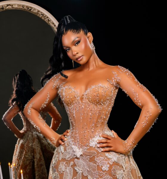 Osas Ighodaro wearing a custom sheer corseted Veekee James lace gown with crystal embellishments