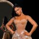 Osas Ighodaro wearing a custom sheer corseted Veekee James lace gown with crystal embellishments