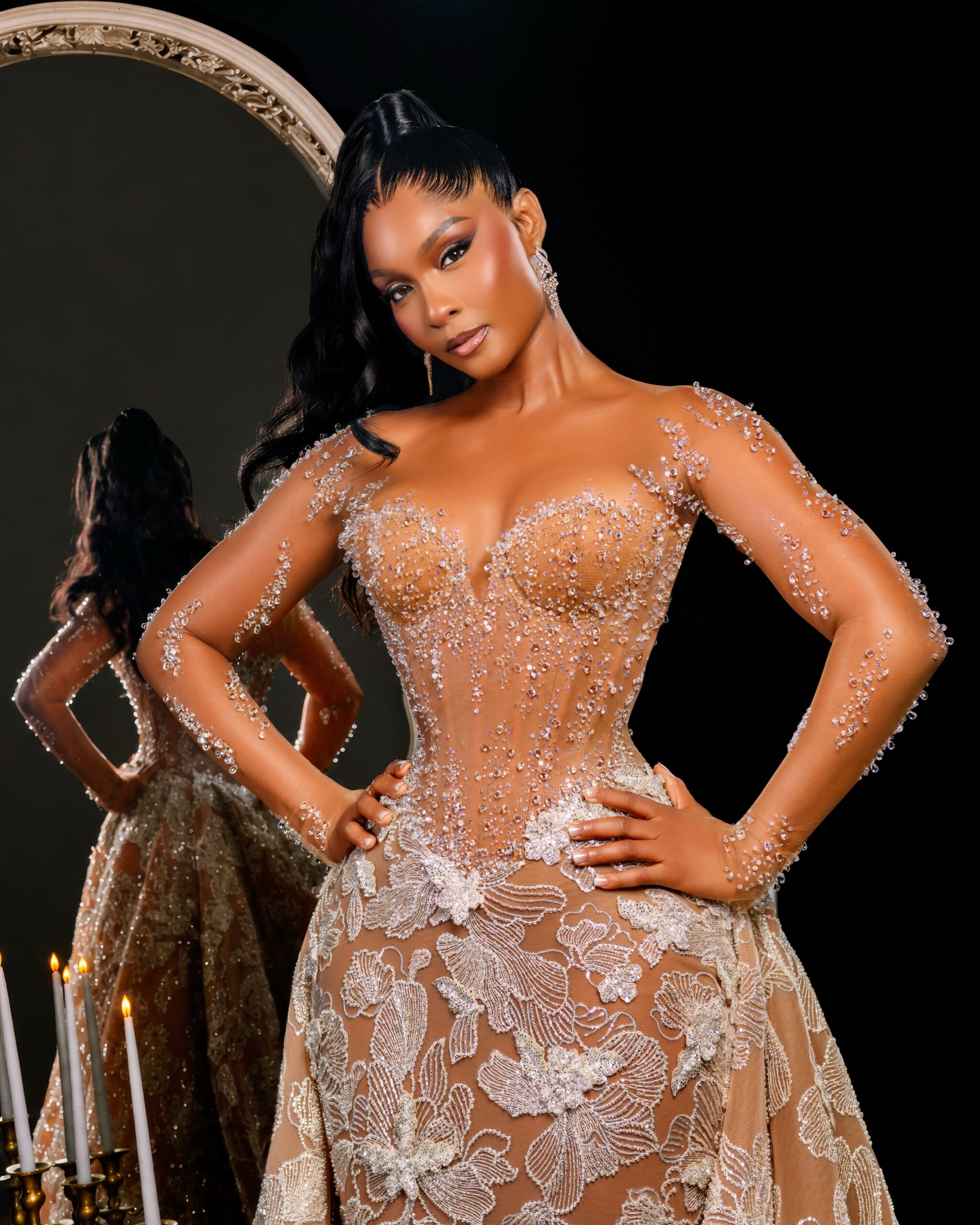 Osas Ighodaro wearing a custom sheer corseted Veekee James lace gown with crystal embellishments