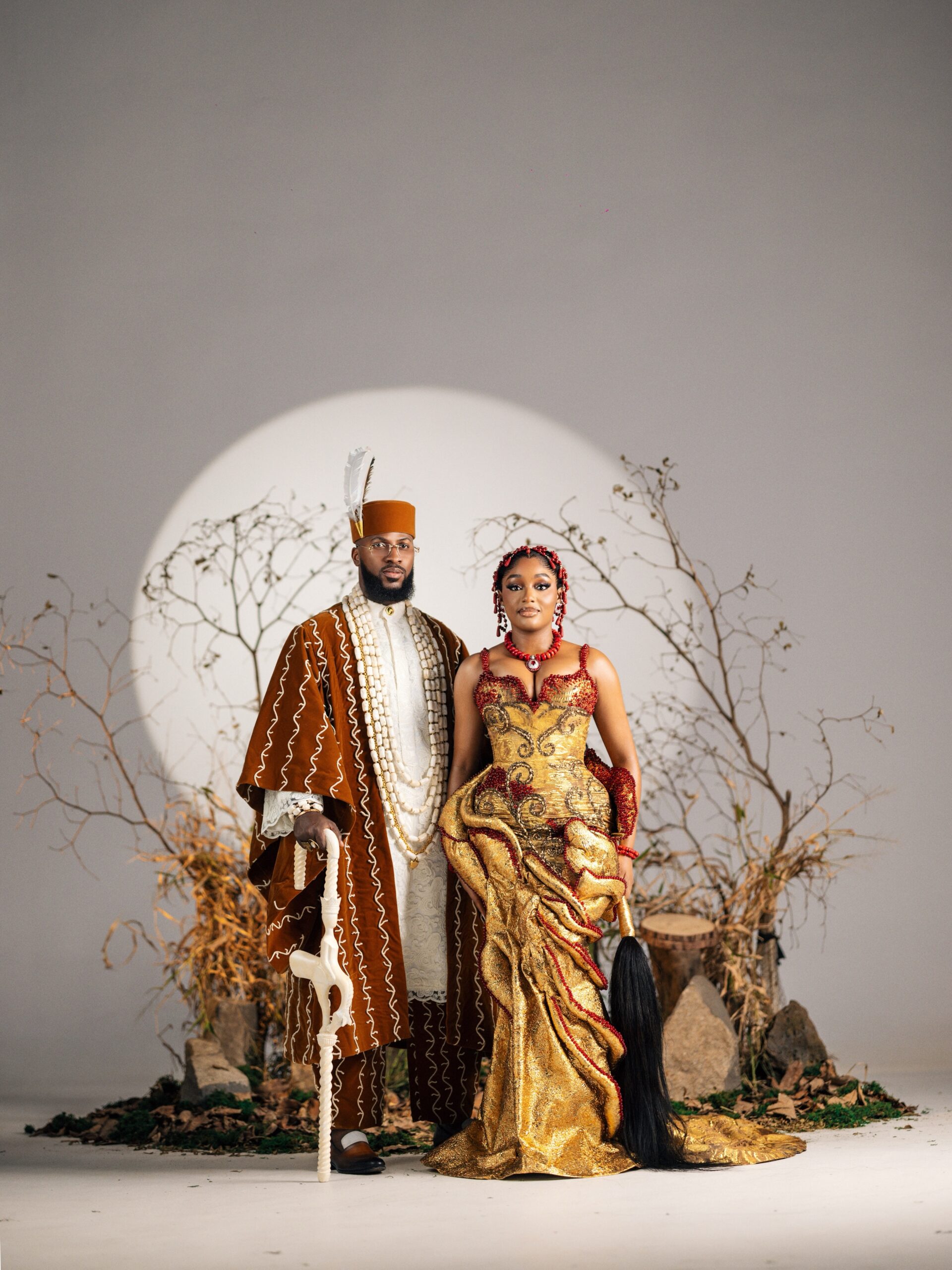 Akin Faminu in a brown velvet Agbada by Deji and Kola and Kiky Festus in a gold Emagine By Bukola gown at their traditional wedding.