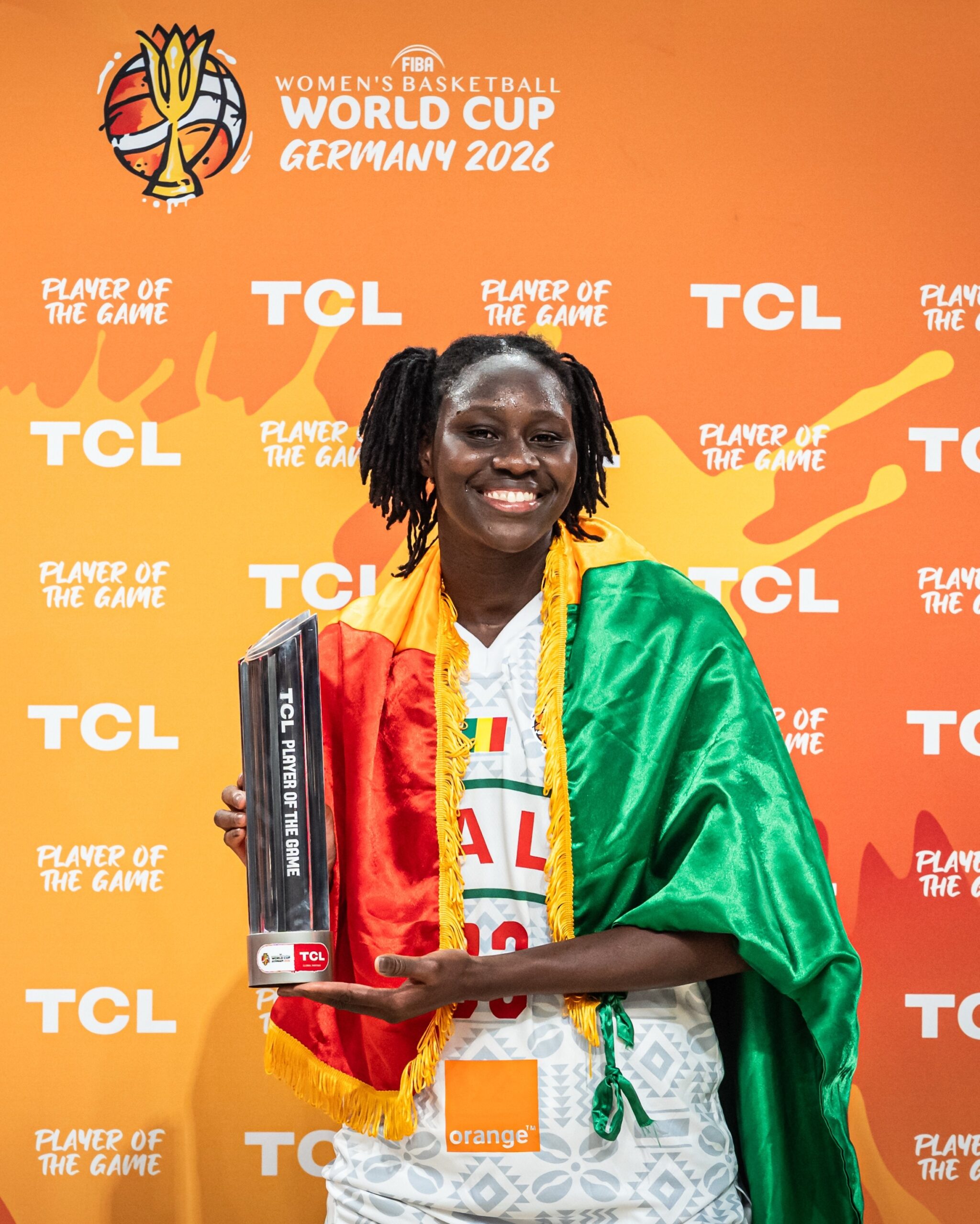 Sika Koné holding her TCL Player of the Game trophy draped in the Malian flag at the FIBA World Cup 2026.