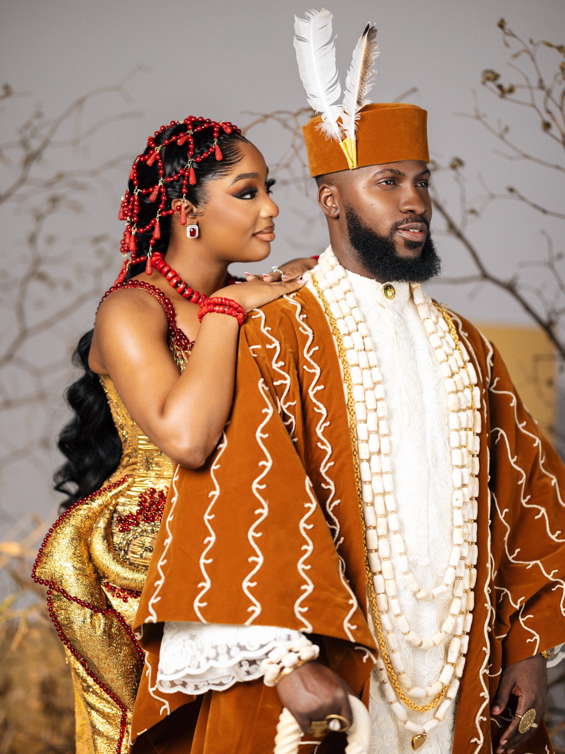 Kiky Festus leaning on Akin Faminu during their traditional wedding ceremony.