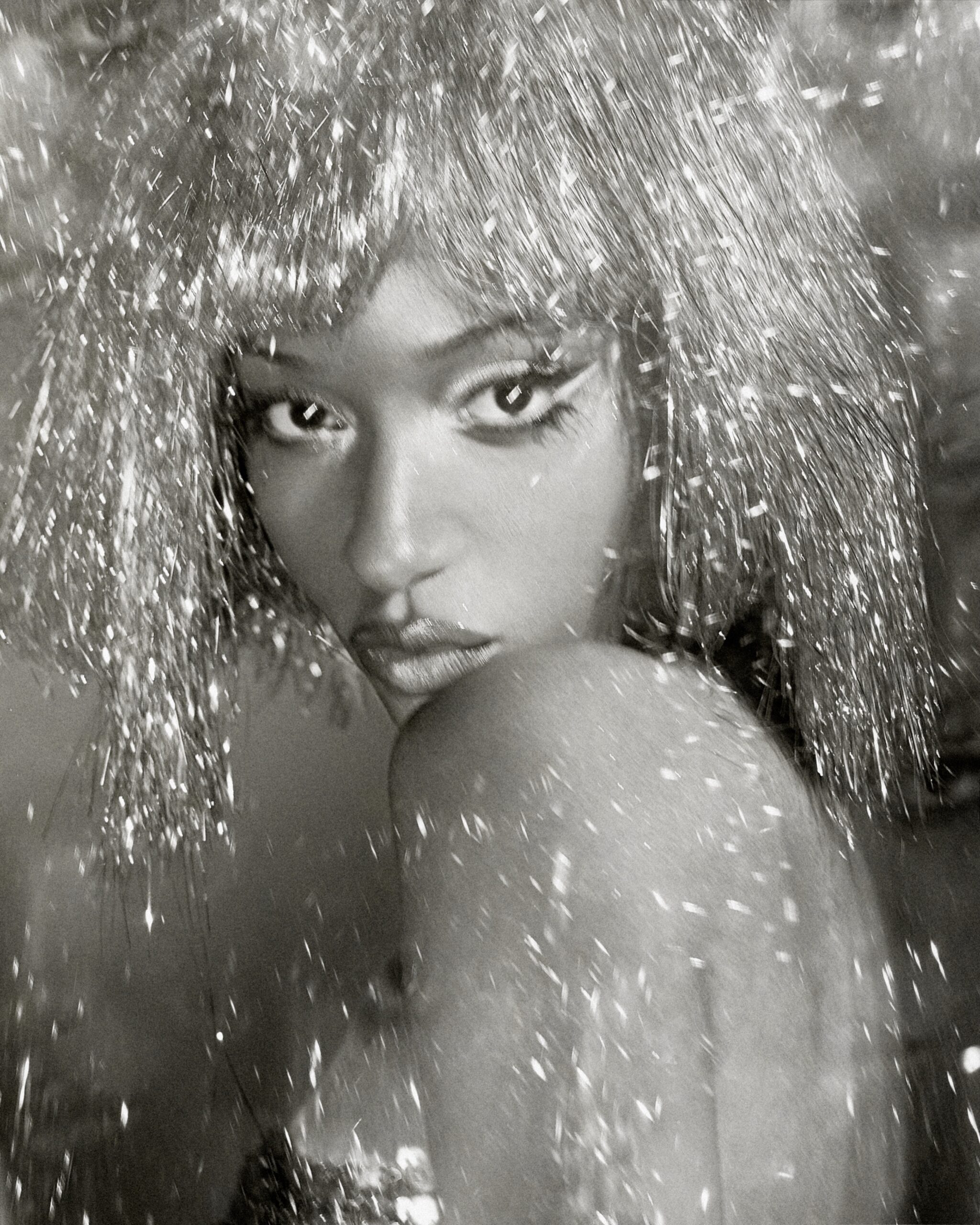 Ayra Starr showcasing metallic silver tinsel fringe hair and graphic white eyeliner, photographed by Fernando Tomaz for 66 GREENE Magazine.