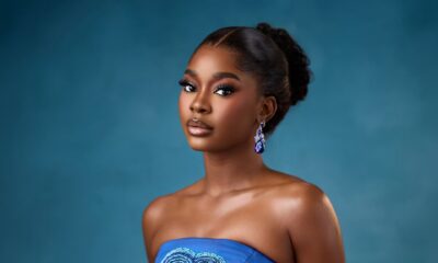 Dede Ashiogwu wearing a strapless royal blue dress with a heart-shaped beaded keyhole cutout and crystal teardrop earrings for the HookedOnTheFaminus white wedding.