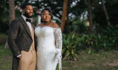 Nollywood actor Stan Nze in P.Aries tailcoat suit with wife Blessing Obasi Nzediegwu in Prudential lace wedding dress at vow renewal ceremony.