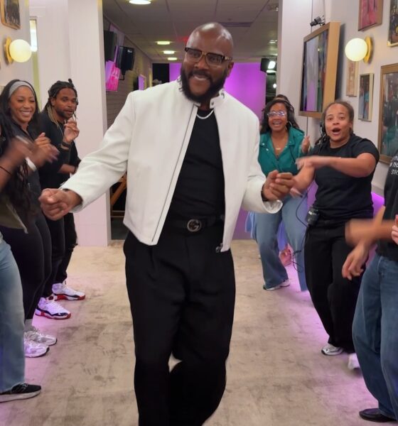 Tyler Perry dancing through The Jennifer Hudson Show Spirit Tunnel wearing a white leather jacket and Gucci belt.