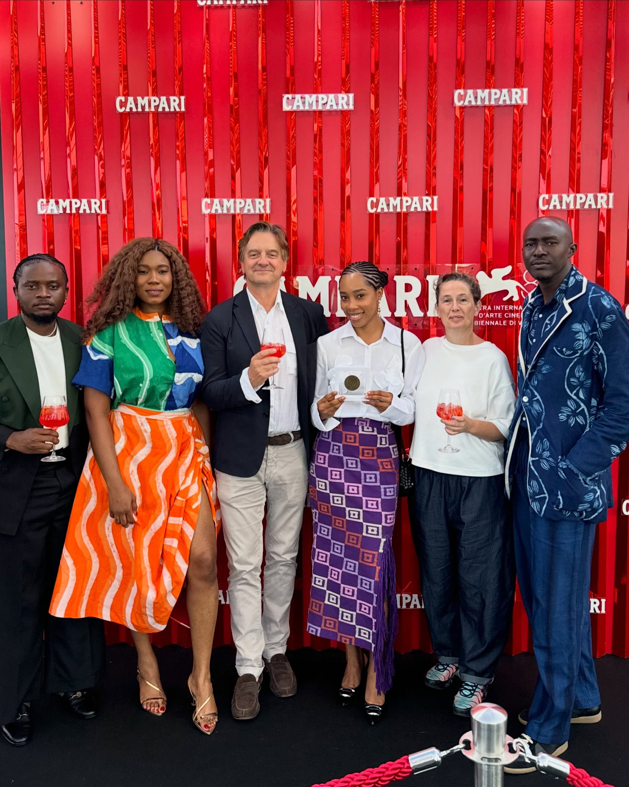 Director Damilola Orimogunje and the Dear Ajayi team holding the Fellini Medal at the Venice Film Festival.