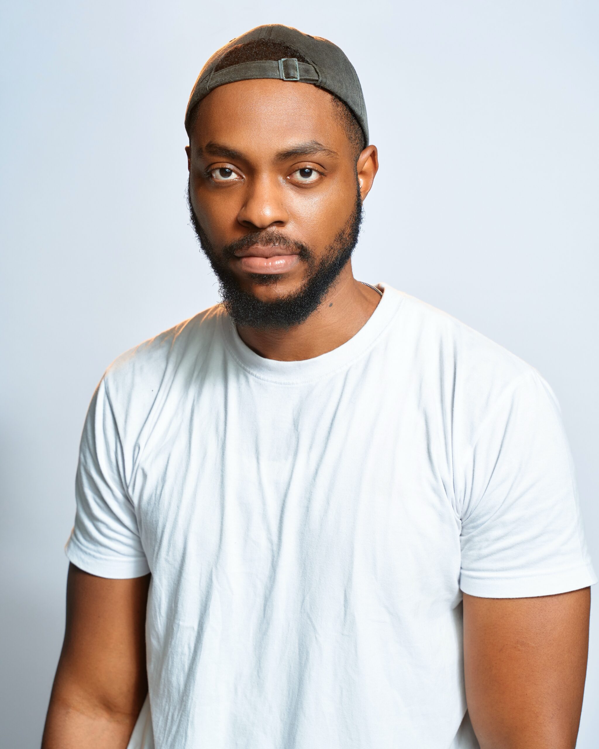 BBNaija Season 11 finalist Ricky in a white t-shirt and grey cap