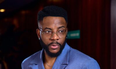 Ebuka Obi-Uchendu wearing a silver crystal brooch on a periwinkle pinstripe double-breasted shirt-jacket by Atafo.