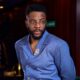 Ebuka Obi-Uchendu wearing a silver crystal brooch on a periwinkle pinstripe double-breasted shirt-jacket by Atafo.