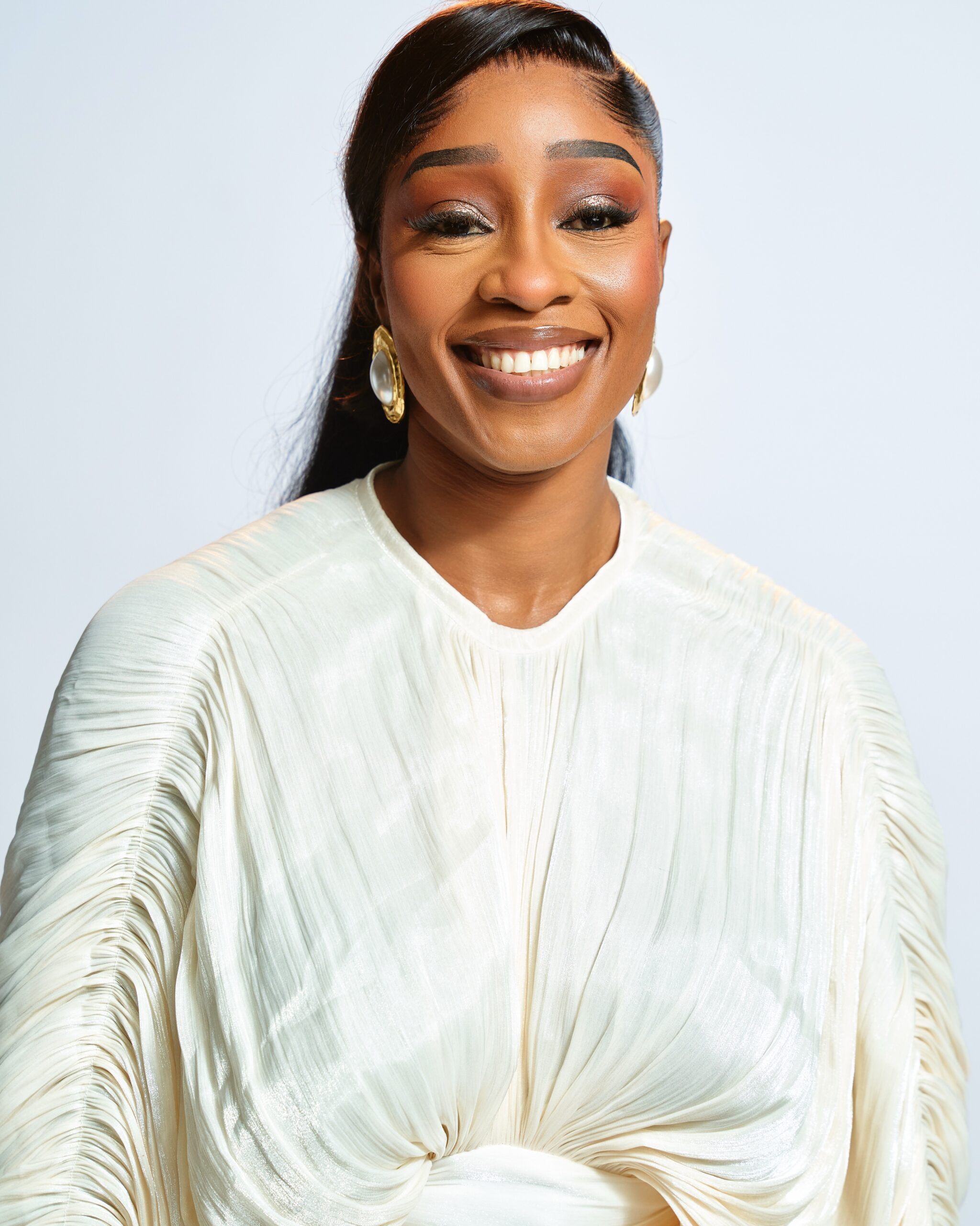 BBNaija Season 11 finalist Sheba smiling in a draped white top