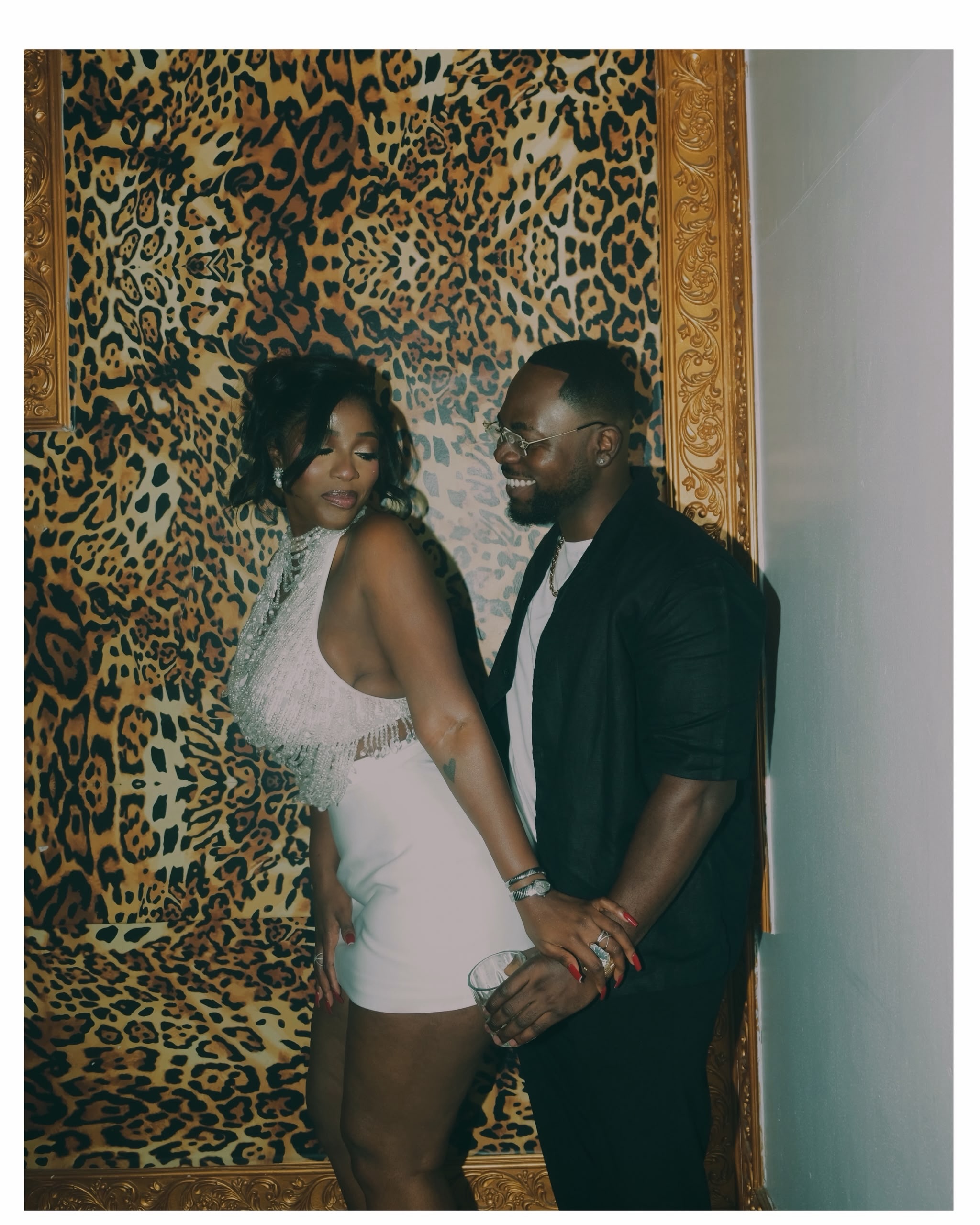 Hilda Baci and Damilola Akinwunmi posing together against a leopard print backdrop