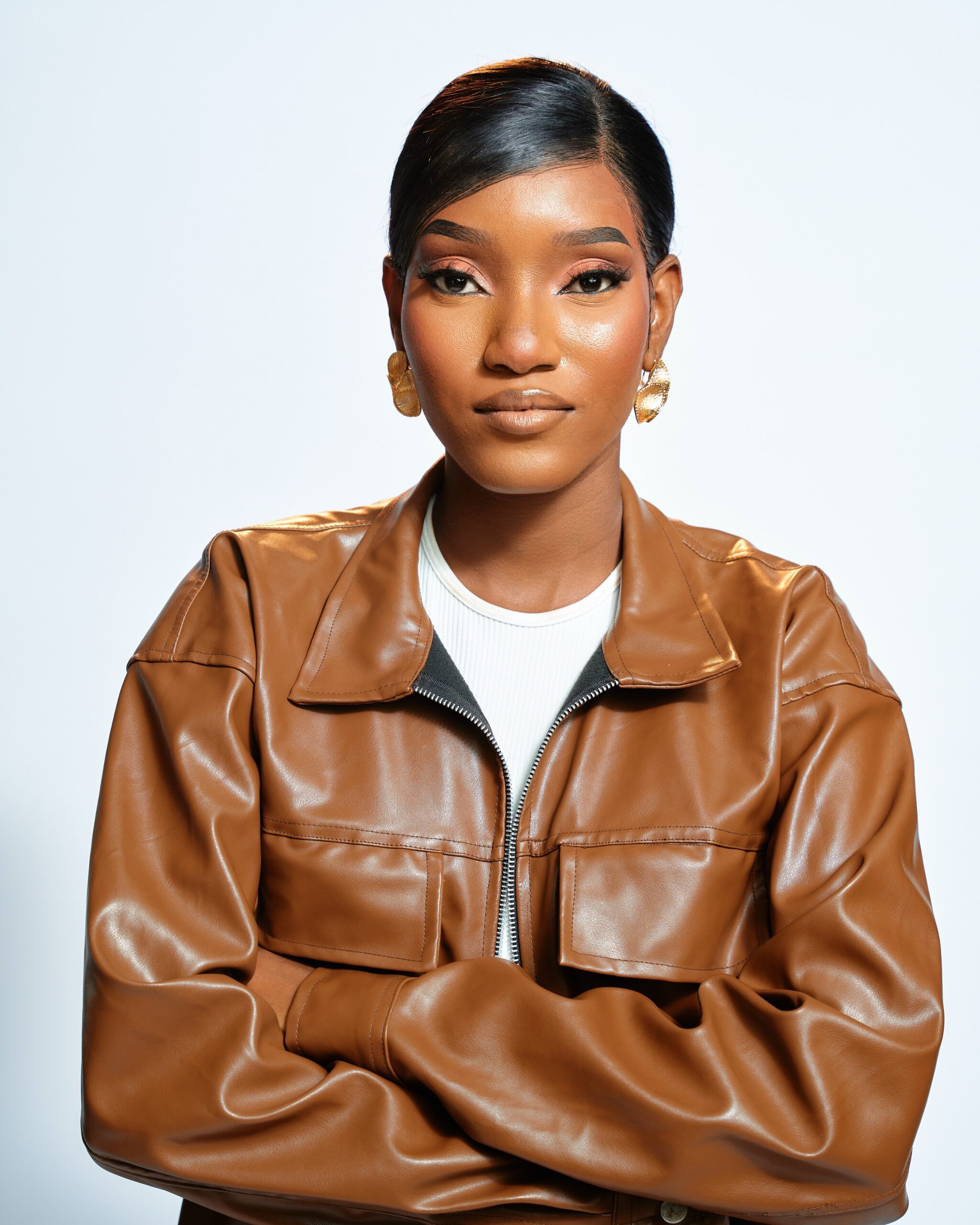 BBNaija Season 11 finalist Oyin posing in a brown leather jacket