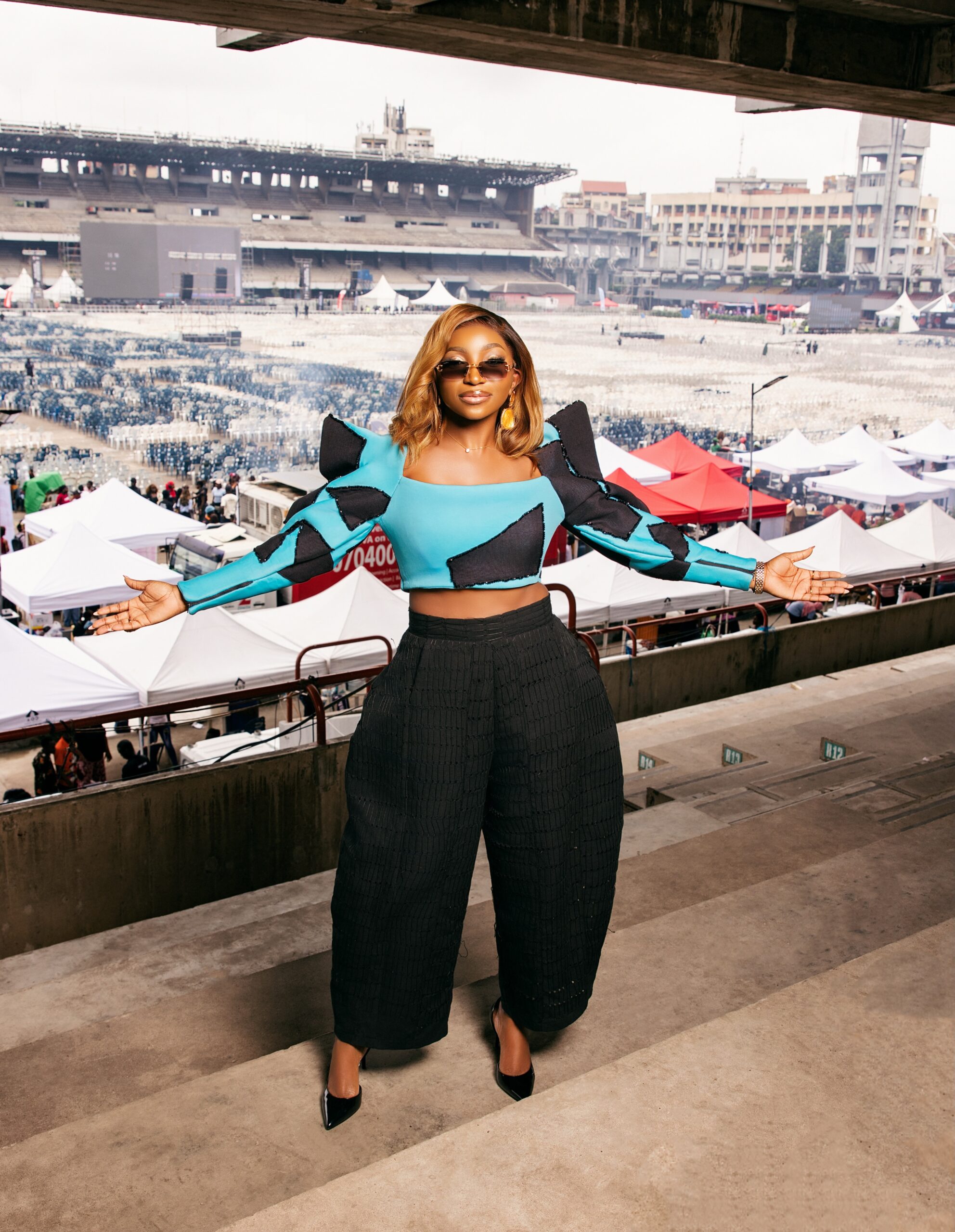 Omowunmi Dada standing in the Tafawa Balewa Square stands ahead of the 51,000 attendee Black Market movie screening