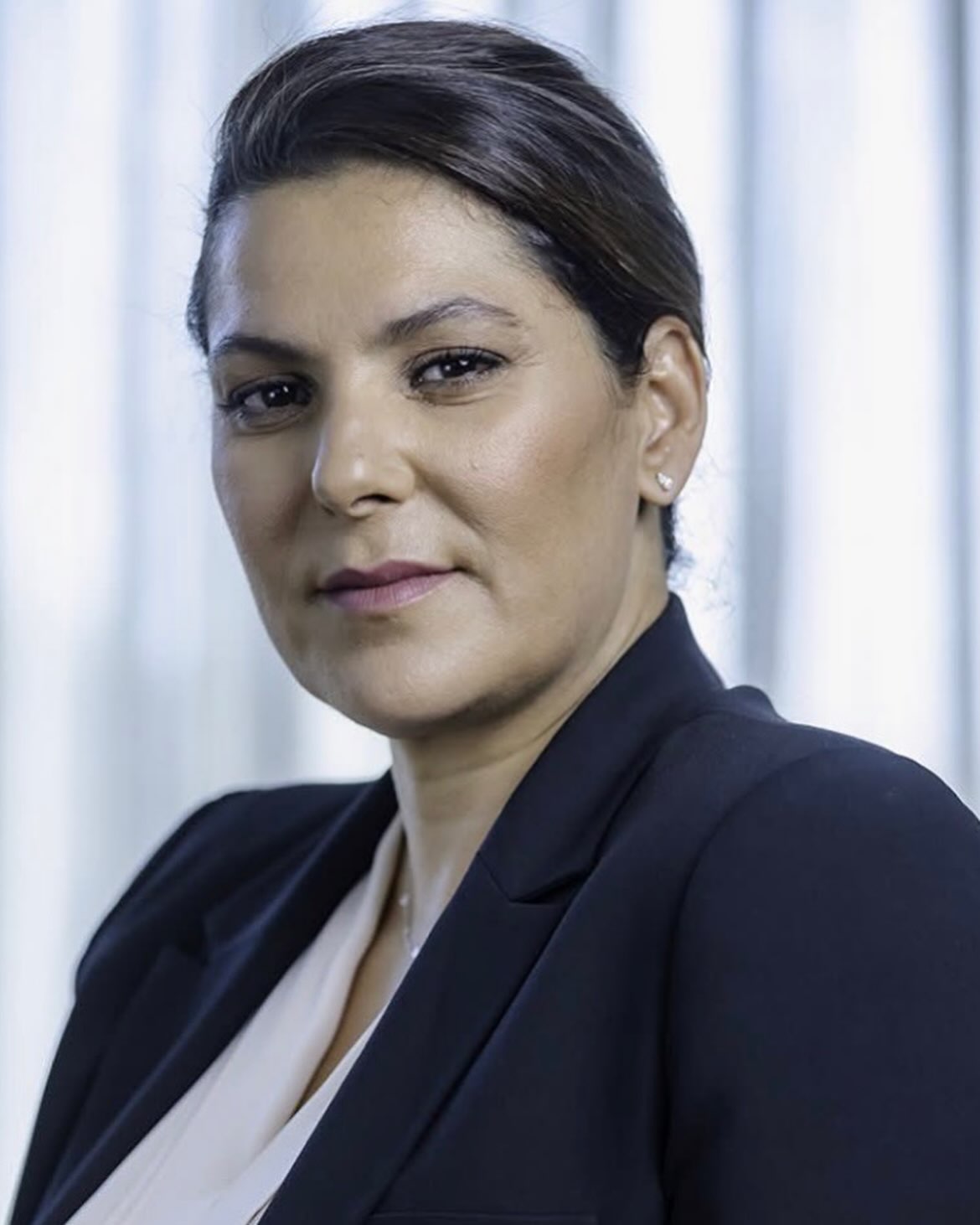 Fatima Ezzahra El Mansouri wearing a dark navy blazer and light top