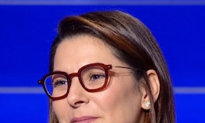 Fatima Ezzahra El Mansouri wearing red frames and a dark blazer