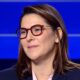 Fatima Ezzahra El Mansouri wearing red frames and a dark blazer