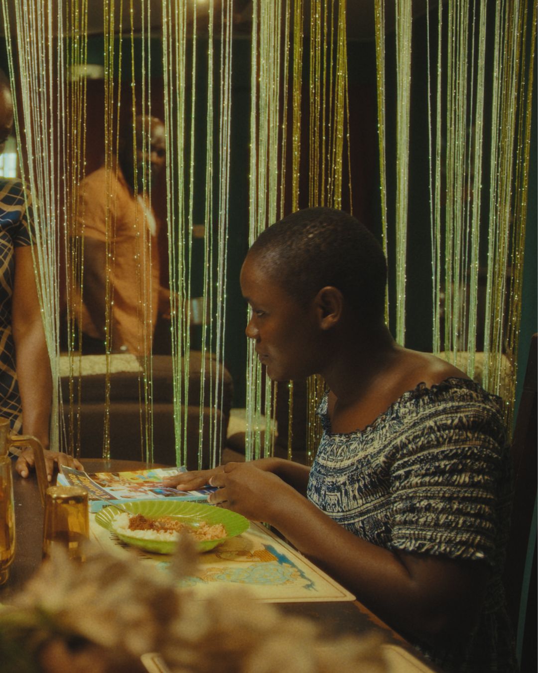 Osas Okonyon playing Ejaita as she studies at the dining table in Her Daughters Mother.