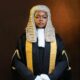 Olamide Mojigbotoluwa Ehinfun-Adekunle wearing the ceremonial Senior Advocate of Nigeria silk gown, gold lace trim, white collar, and full legal wig.