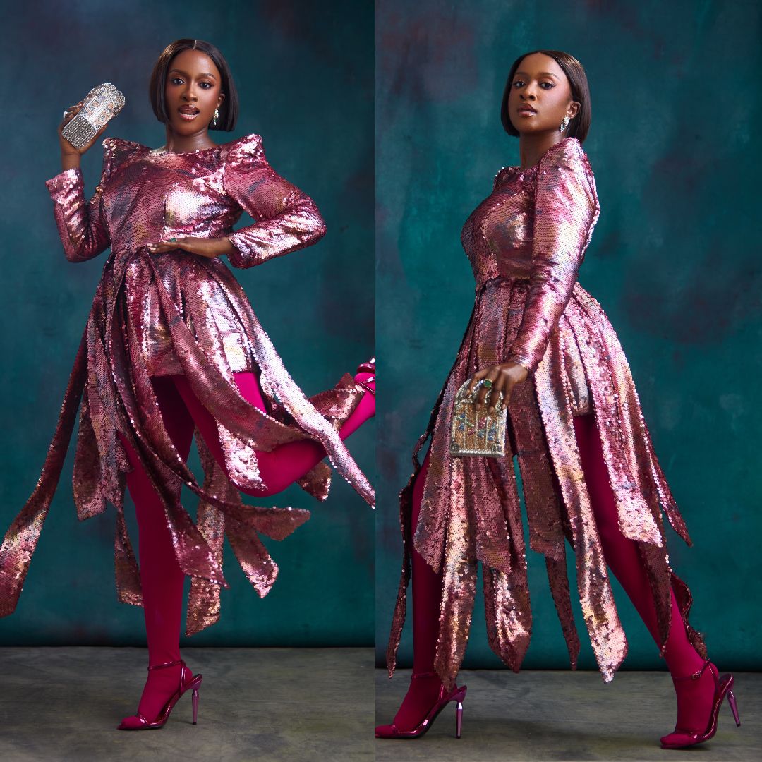 Genoveva Umeh in a magenta and rose-pink sequined dress with asymmetrical handkerchief ribbons and matching pink tights.