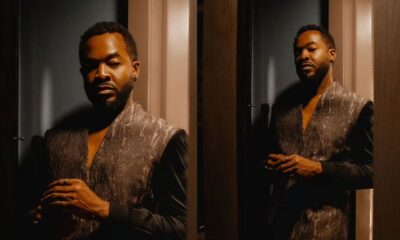 OC Ukeje wearing a dark textured longline tunic vest over a long sleeve shirt for the BellaNaija 20th anniversary celebration.