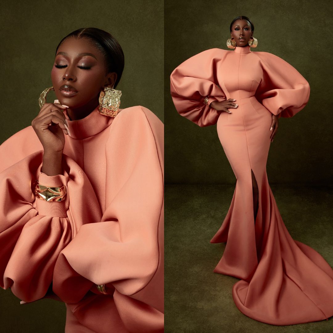 Nelly Mbonu in coral peach high-neck floor-length gown with exaggerated bishop sleeves at BellaNaija 20th Anniversary Grand Red Carpet Experience.