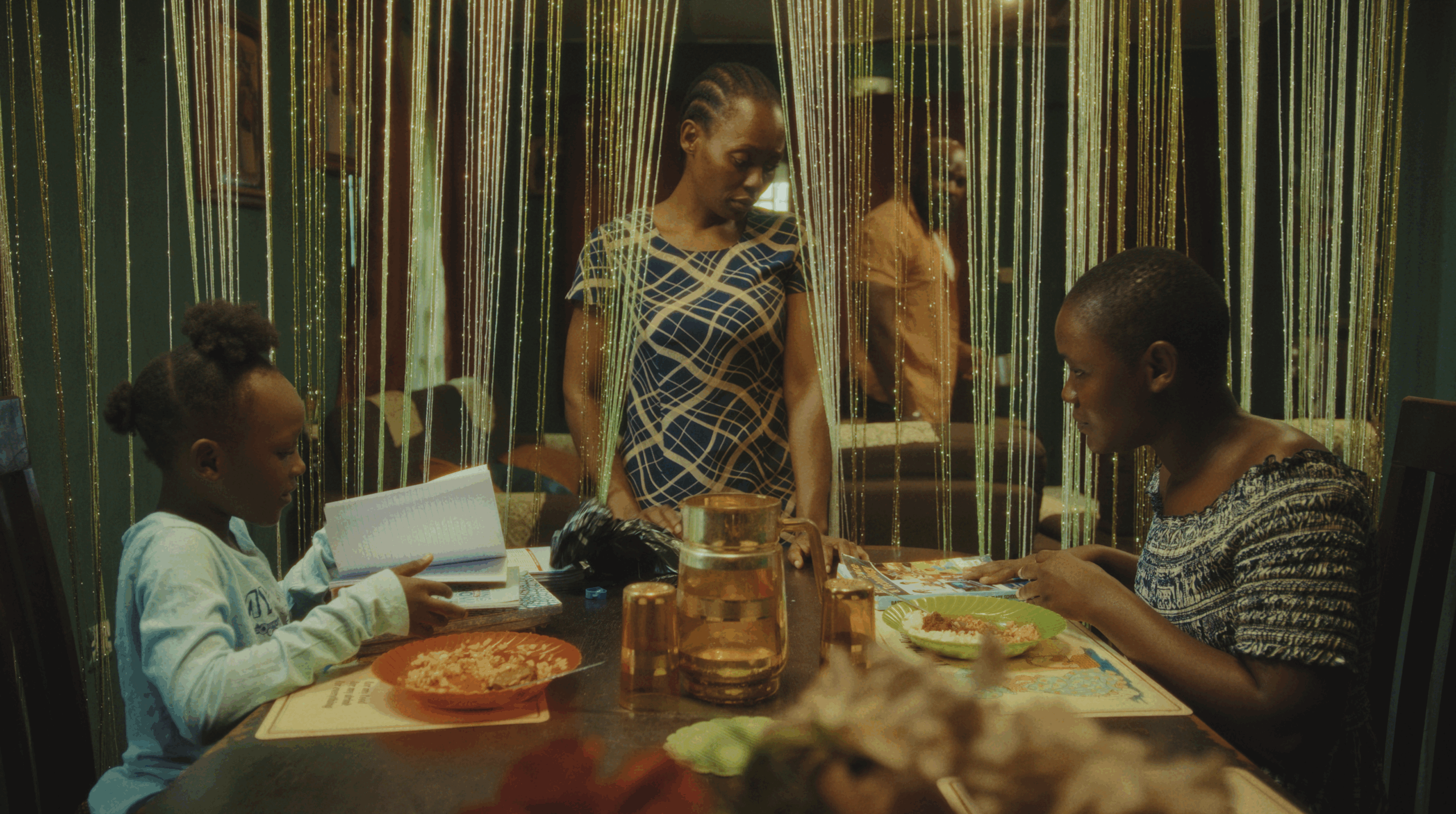 Silhouette of a character beside a boiling kettle in Her Daughters Mother featuring the Film Africa 2026 laurel