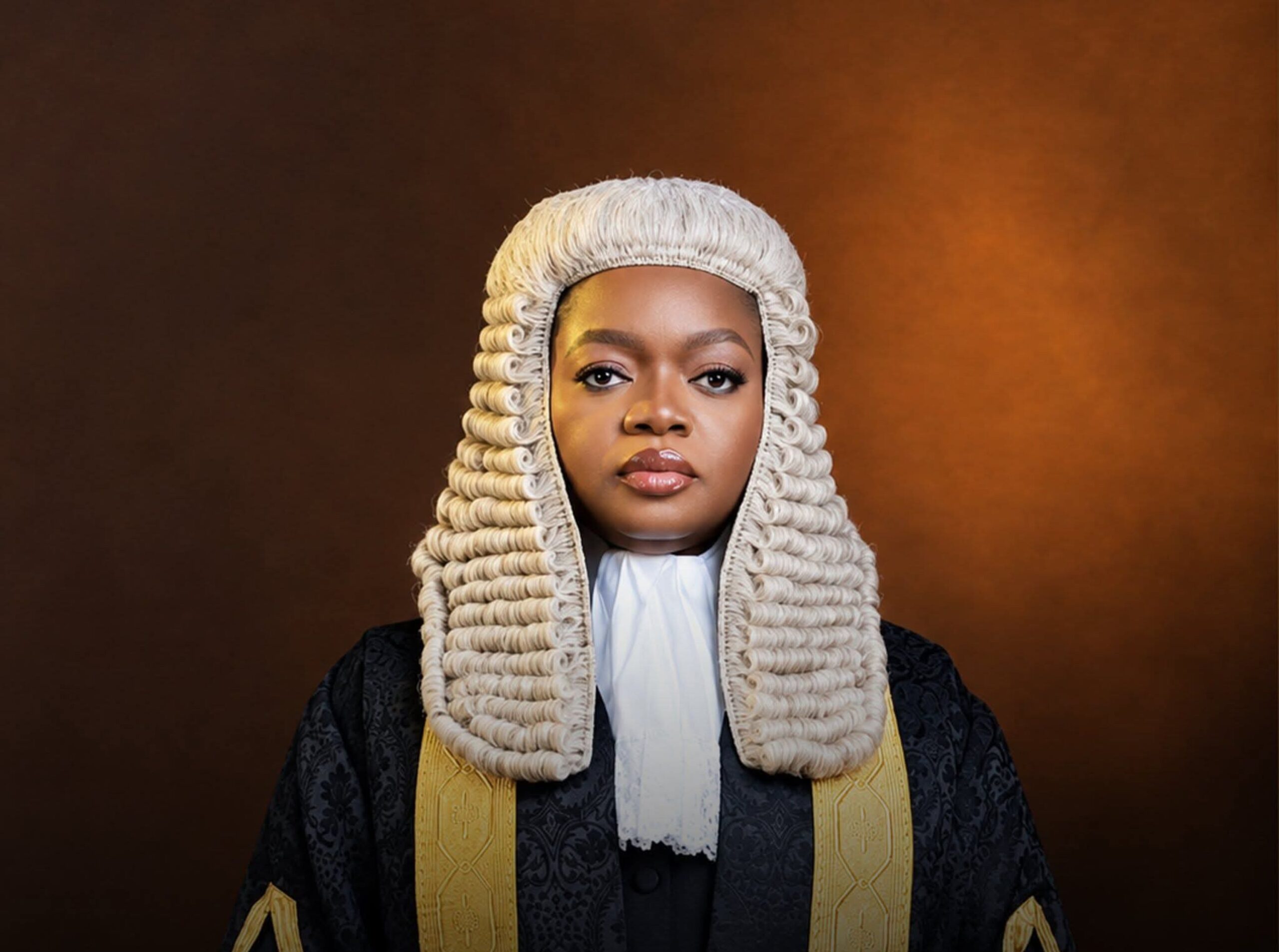 Olamide Mojigbotoluwa Ehinfun-Adekunle SAN wearing a full-bottomed legal wig, white bib collar, and black silk gown.