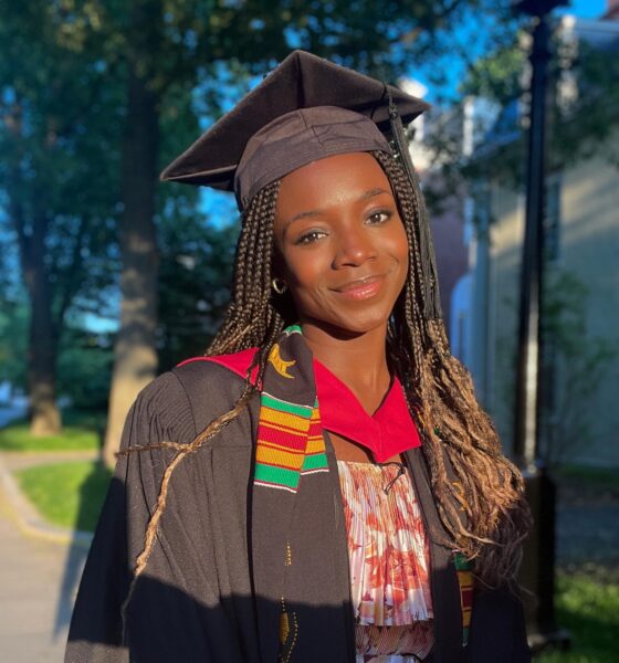 Nigerian-born engineer Yinka Ogunbiyi wearing a graduation gown, cap, and kente stole at Harvard.