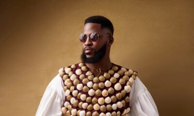 Dr Akin Faminu wearing Mekallia cowrie-shell encrusted vest over billowy white shirt with round sunglasses for The Devil Wears Prada 2 Lagos premiere.