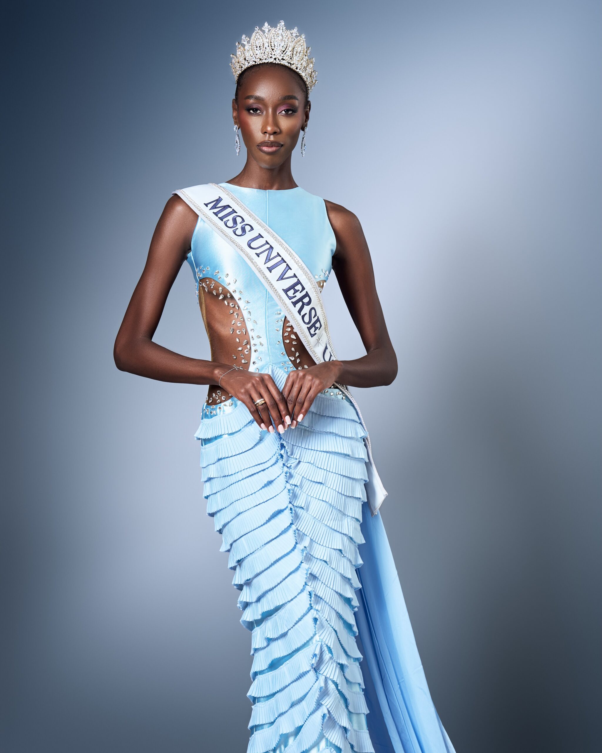 Mitchelle Daka in a light blue textured gown wearing her Miss Universe Uganda 2026 crown and sash.