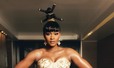 Osas Ighodaro wearing a strapless ivory corset with gold embroidery and threaded updos at the BellaNaija Grand Red Carpet Experience.