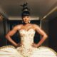Osas Ighodaro wearing a strapless ivory corset with gold embroidery and threaded updos at the BellaNaija Grand Red Carpet Experience.