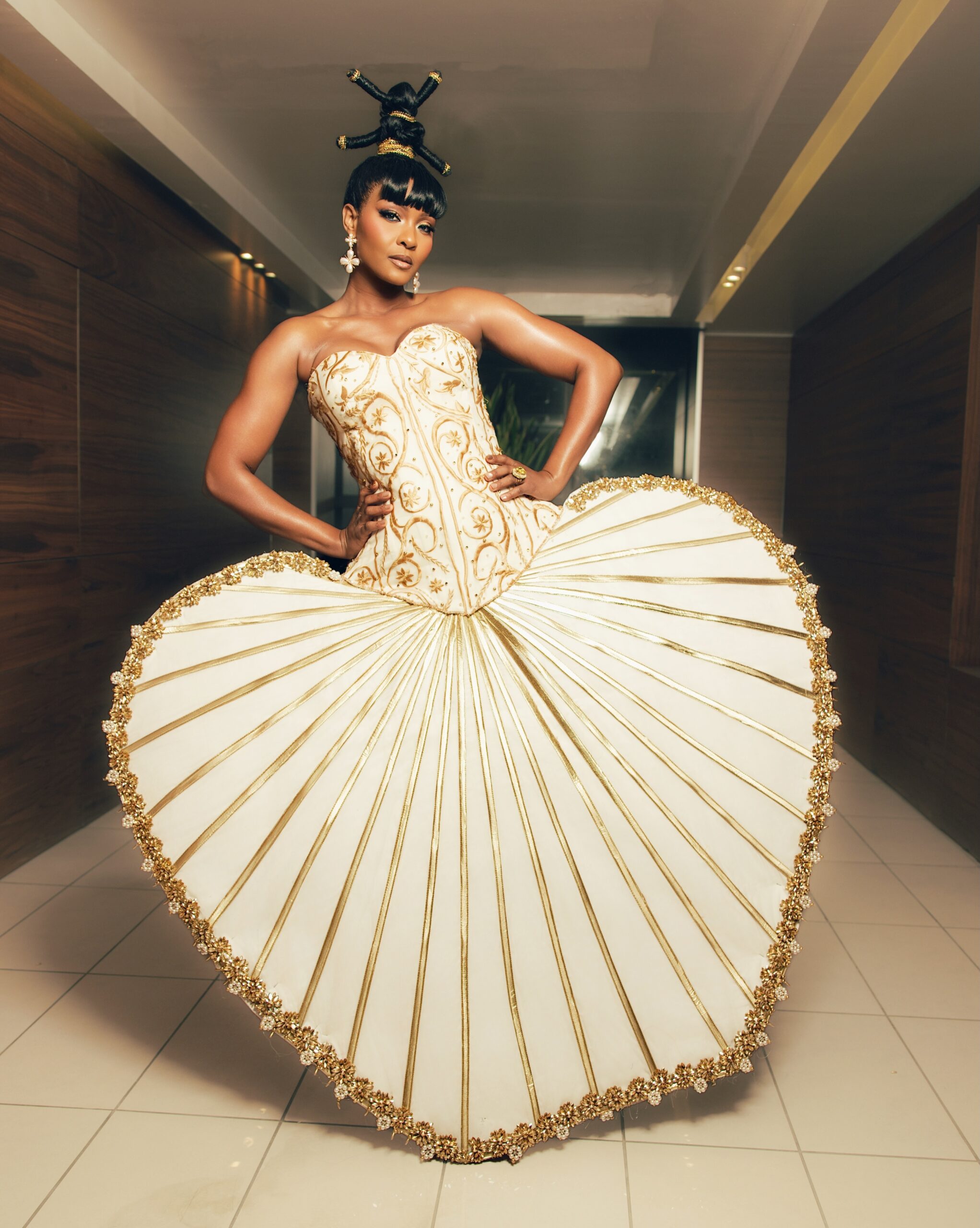 Osas Ighodaro in a full-length ivory and gold heart-silhouette gown for the High Fashion Icon theme at BellaNaija Grand Red Carpet.