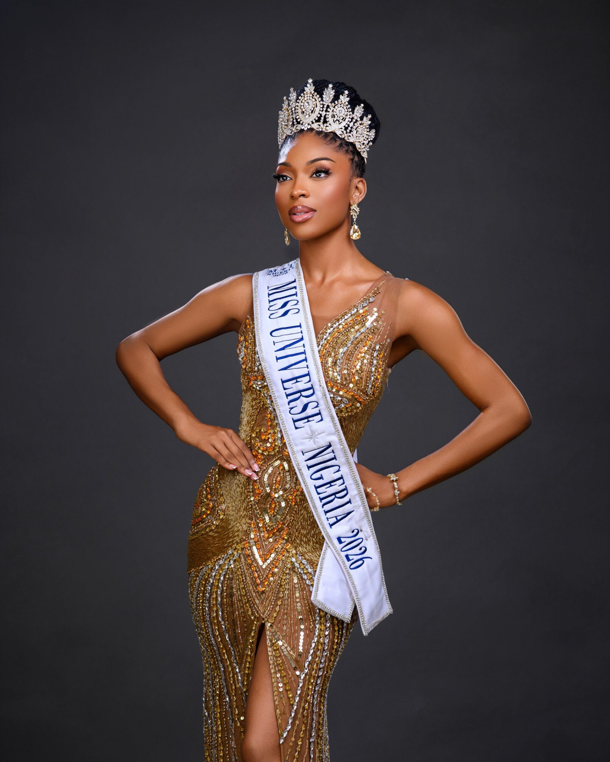 Dr Danielle Adewusi wearing a gold embellished gown with her Miss Universe Nigeria 2026 sash and crown.