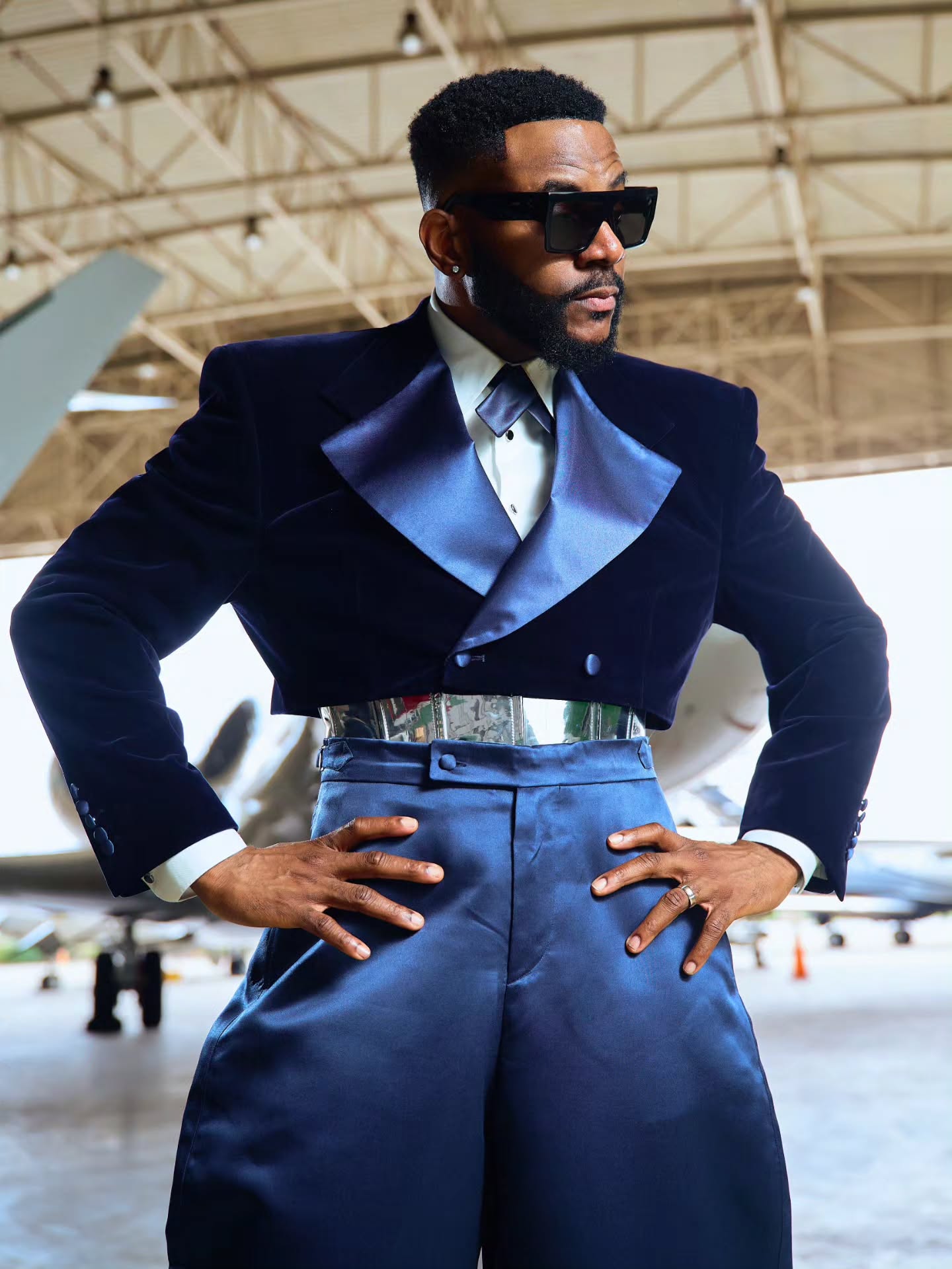 Ebuka Obi-Uchendu showing the silver metallic belt plate and slate blue lapels of his Mai Atafo tuxedo.