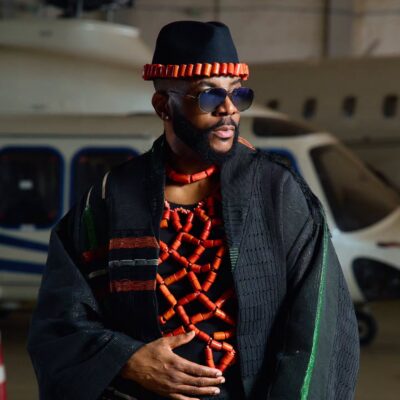 Ebuka Obi-Uchendu wearing a webbed coral bead torso piece under a black hand-woven Atafo coat for BBNaija Season 11 grand finale.