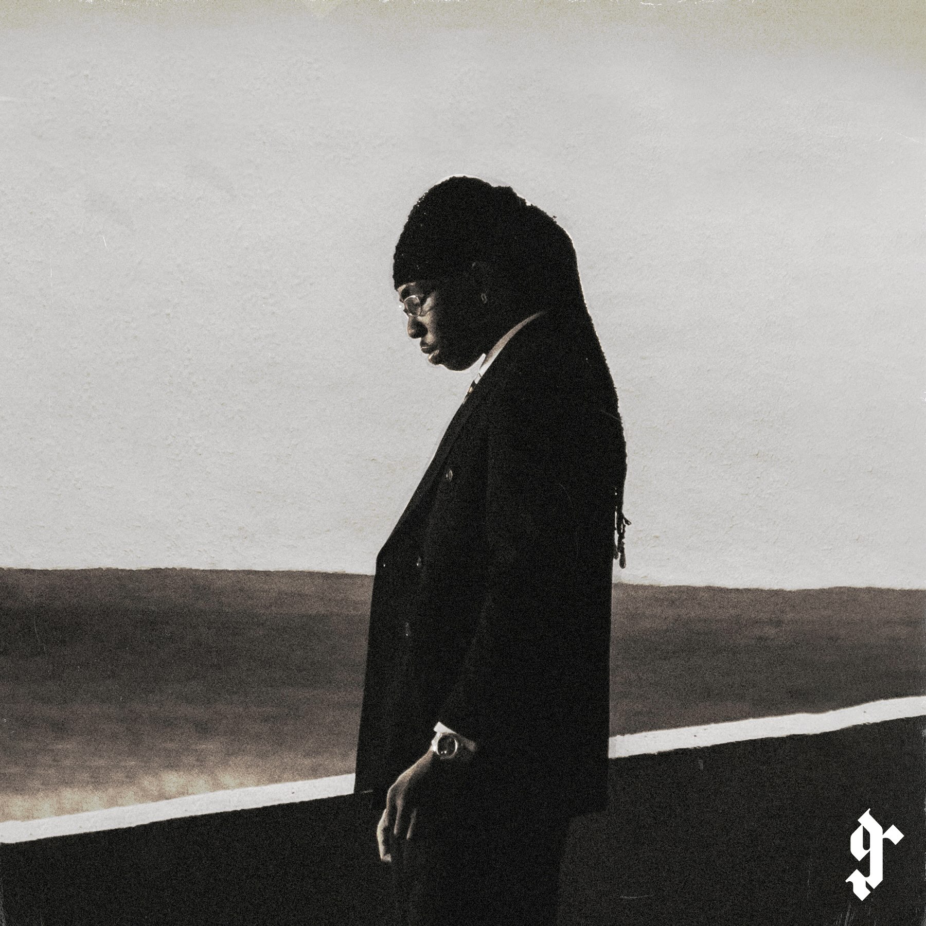 Afrobeats singer FOLA standing in a suit against a monochrome backdrop announcing his sophomore album 9.