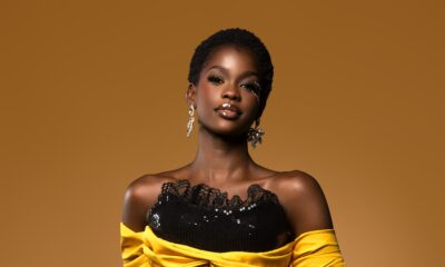 Kimberly Jael in a black sequined corset dress with yellow off-the-shoulder fabric and a ruched red skirt.