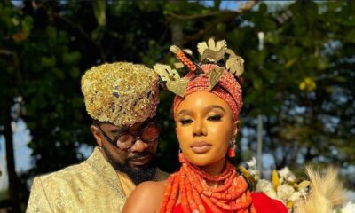 Uzor Arukwe in a gold brocade outfit standing behind Nancy Isime in red traditional Edo attire and coral beads for Loving Itohan.