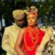 Uzor Arukwe in a gold brocade outfit standing behind Nancy Isime in red traditional Edo attire and coral beads for Loving Itohan.