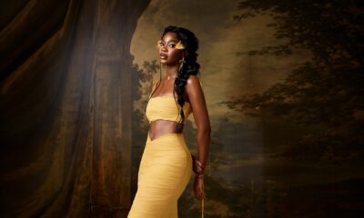 Ashiogwu Precious Dede in a low-rise butter yellow maxi skirt with a sweeping train and bandeau top.